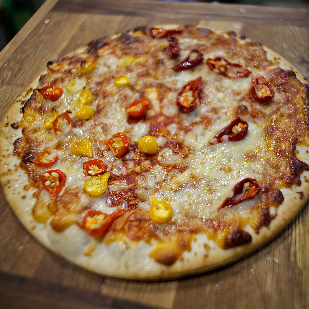  World of Chillies: Homemade cheese pizza topped with red and yellow Biquinho chillies, freshly baked until golden. 